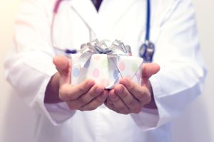 gifts for healthcare workers: a healthcare provider holding a gift