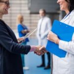healthcare staffing industry trends - a doctor and a hiring manager shaking hands