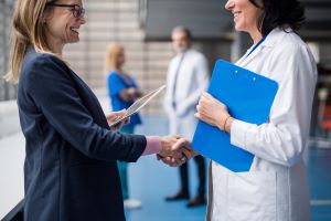 healthcare staffing industry trends - a doctor and a hiring manager shaking hands