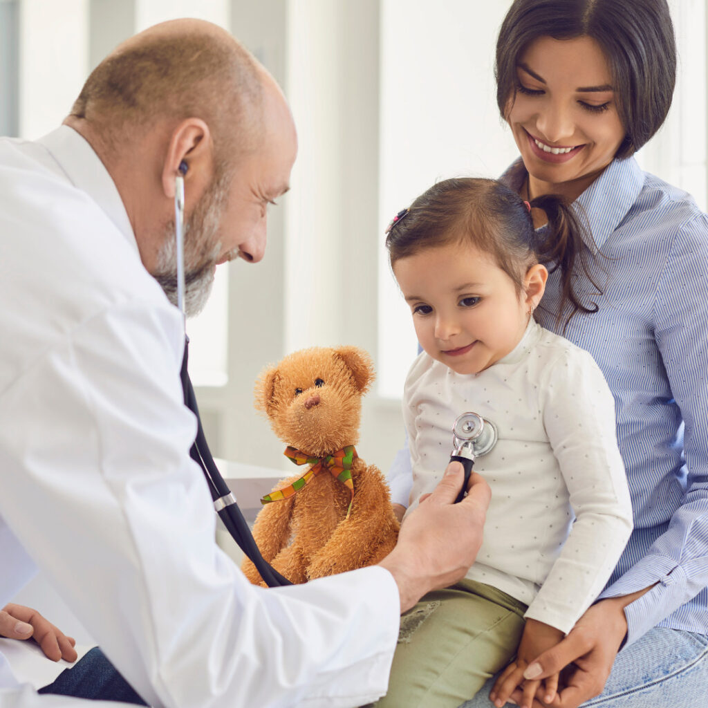 A doctor listens to a child's breathing through a stethoscope