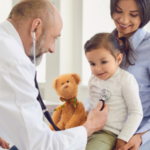 A doctor listens to a child's breathing through a stethoscope