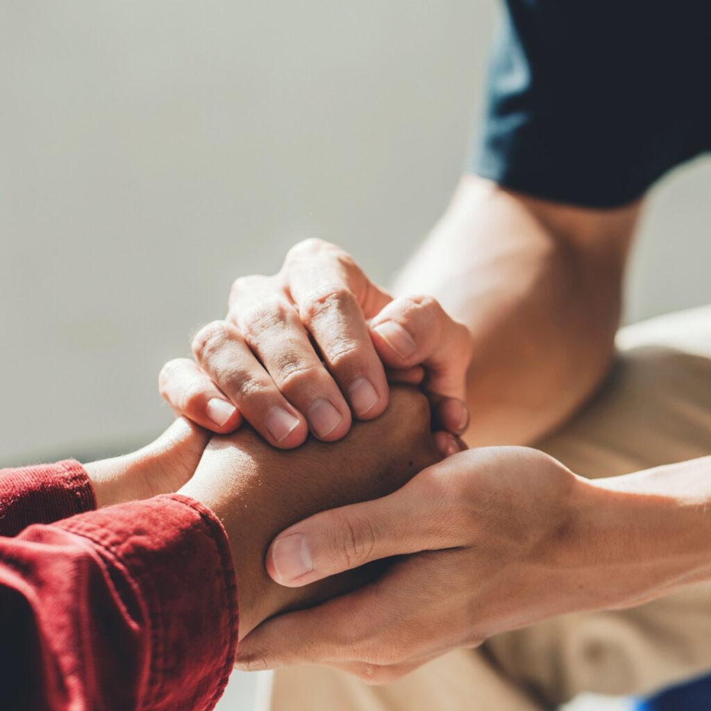 Two people holding hands