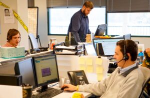 Three people working in an office