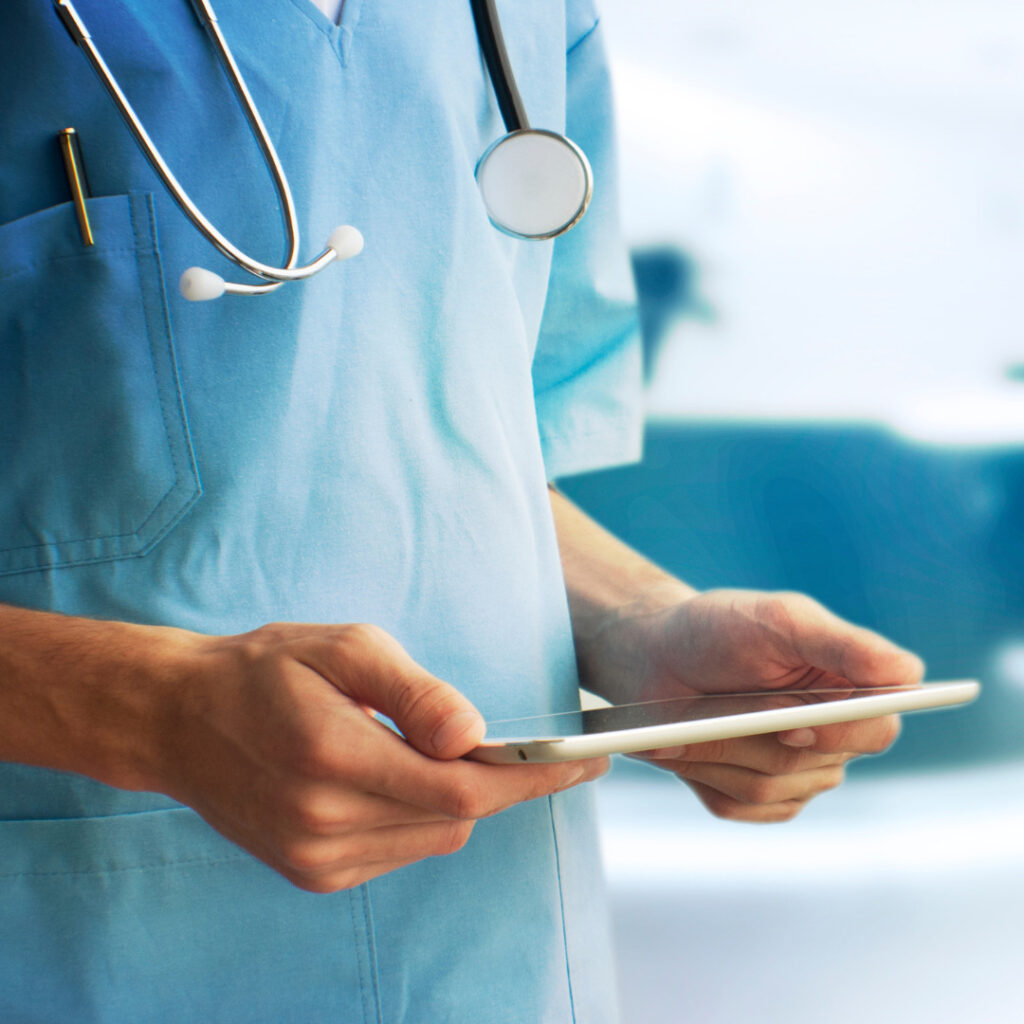 A nurse looking at a tablet