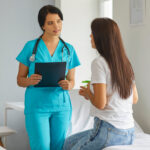 A nurse practitioner (NP) talks to a patient