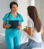 A nurse practitioner (NP) talks to a patient