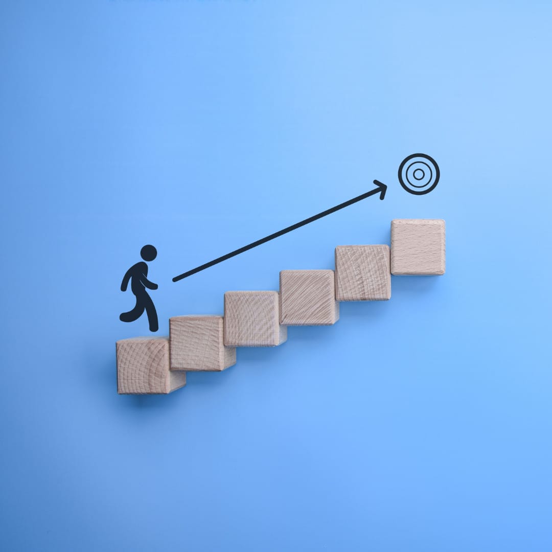 An illustration of a person moving up stairs toward a goal