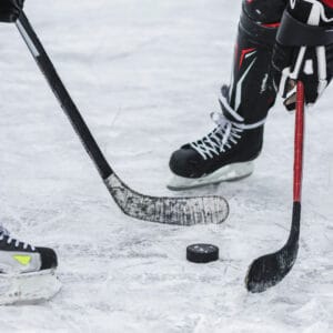 Two people playing hockey