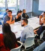 A staff meeting in Barton Associates' Tempe, AZ office