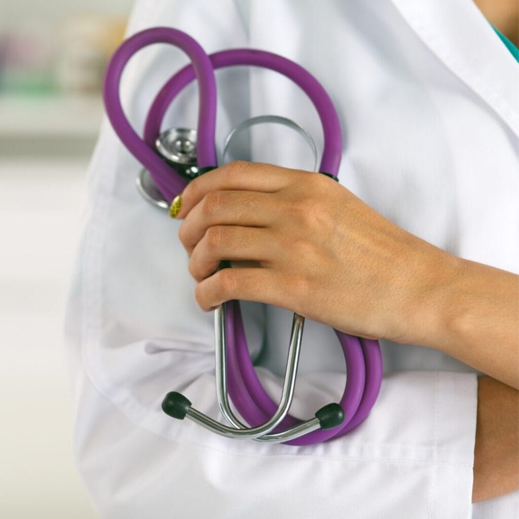 A physician assistant holds a stethoscope 