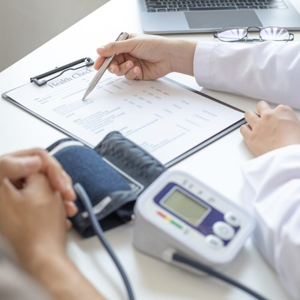 A doctor writing on a health checkup note