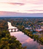 Virginia sunset over river, trees, city