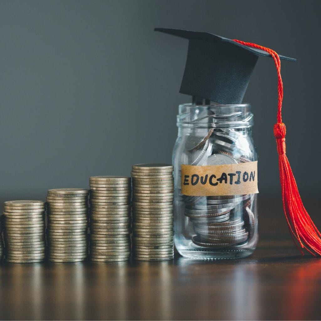 Coins leading up to a jar with a graduation cap on it for a blog titled: How to Pay off Your Student Loans Fast: 4 Tips and FAQs