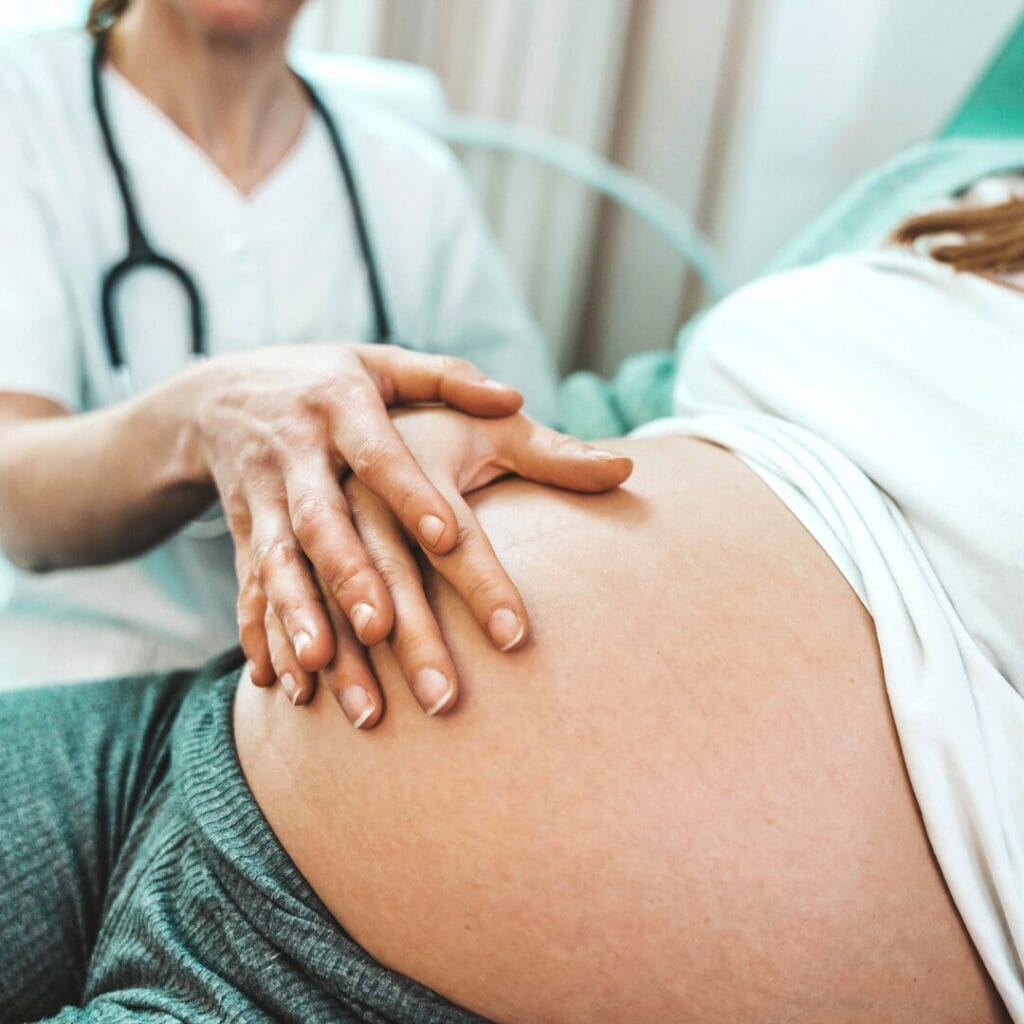 An OB/GYN checking on a patient for a blog about OB/GYN employment opportunities