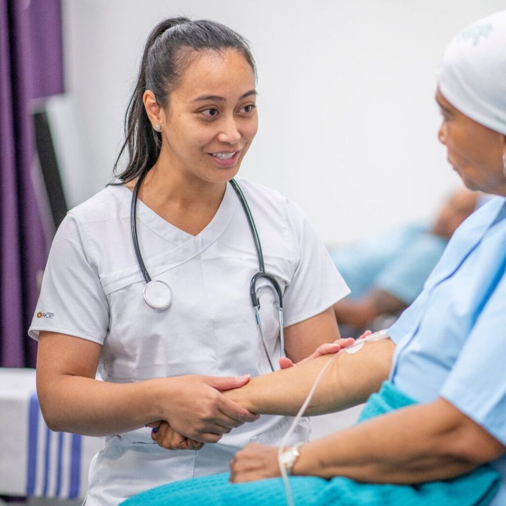 An oncologist working with a patient for a blog on hematology/oncology job opportunities