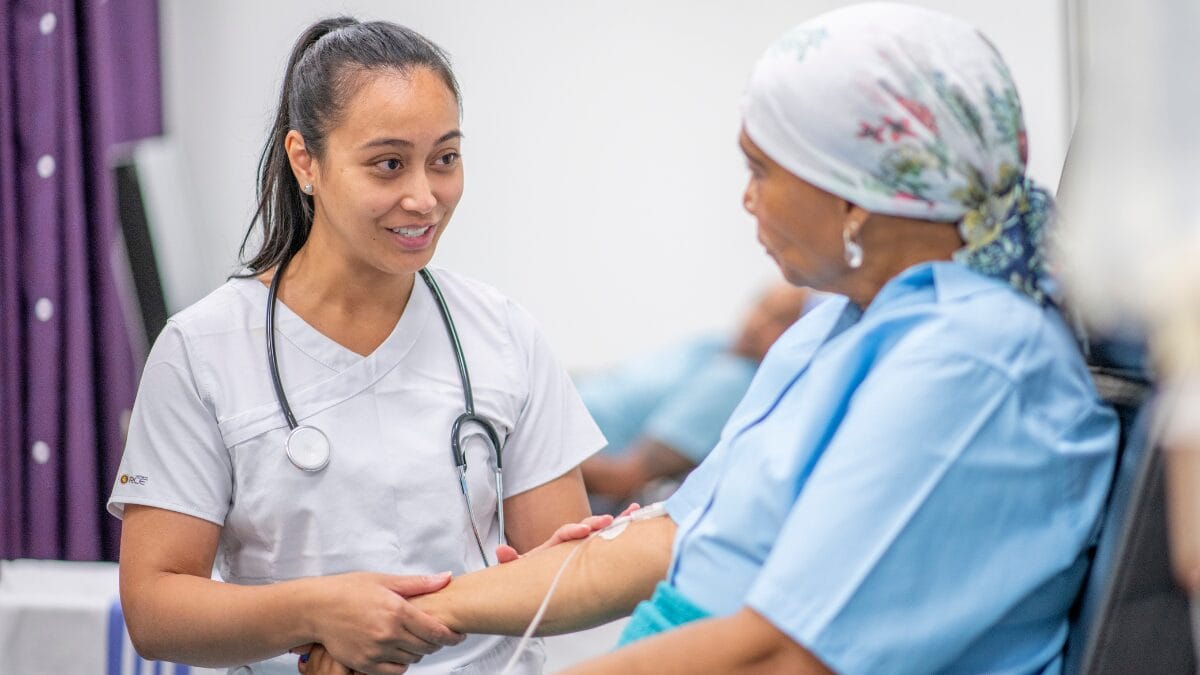 An oncologist working with a patient for a blog on hematology/oncology job opportunities featured image